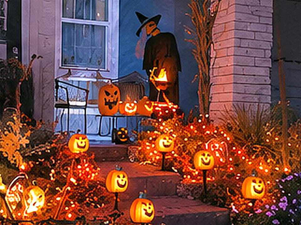 Front steps lined with glowing jack-o'-lantern stakes
